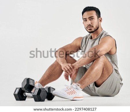 If youre persistent youll get it - if youre consistent youll keep it. Studio portrait of a muscular young man posing with dumbbells against a white background.