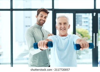 You're stronger than you think. Shot of a friendly physiotherapist helping his senior patient work out with weights. - Powered by Shutterstock