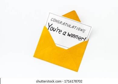 You're a winner. Envelope with congratulation card on white table top view