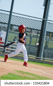 Youth Baseball Boy Swinging The Bat.