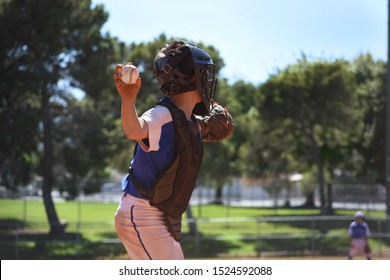 Youth Baseball Catcher With Ball, About To Throw 