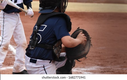 Youth Baseball Catcher, With Ball And Dirt In Glove Ready To Throw