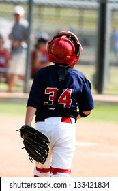 Youth Baseball Catcher Walking About To Home Plate During A Game.