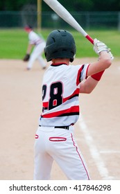 Youth Baseball Kid Holding Bat At Home Plate.