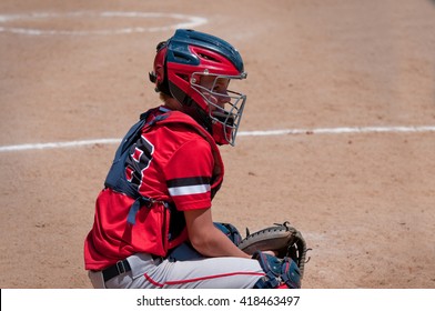 Youth Baseball Kid Squatting Behind Home Plate.