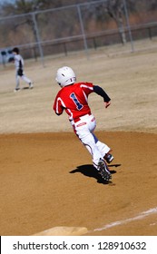 Youth Baseball Player Round First Base.