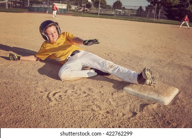 Youth Baseball Playing Sliding To Second Base.