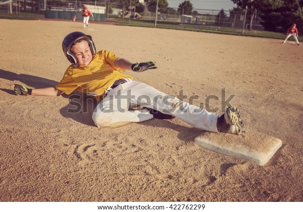 Youth Baseball\
playing sliding to second\
base.