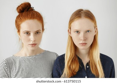 Youth And Beauty. Human Appearance. People And Emotions. Siblings. Sisters. Two Female Friends Wearing Stylish Clothes, Posing With Serious Look, Thinking About Homework, School Mates And Walk