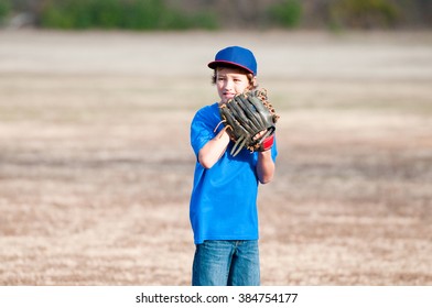 Youth Boy In The Backyard Playing A Game Of Baseball With A Glove.