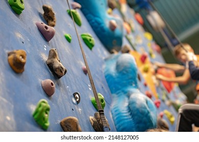 Youth At Climbing Summer Camp. School Kids At Indoor Climbing Wall. Kid Having Fun At Bouldering Wall. Child Learning At Climbing Class. Sports Healthy Lifestyle