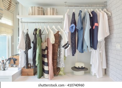 Youth cloths hanging in open wardrobe in the bedroom - Powered by Shutterstock