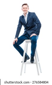 Youth And Confidence. Attractive Young Man Sitting On Chair. Isolated On White.