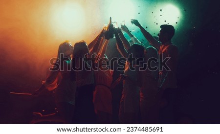 Youth culture, lifestyle. Vising concert. Group of young, active people at the night club, party dancing in neon lights. Concept of party, fun, holiday, relaxation, meeting Copy space for ad