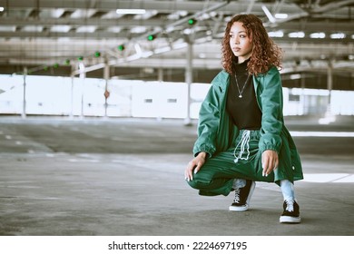 Youth, fashion and black woman with streetwear in an urban city parking lot for design, brand and hip hop lifestyle. Young woman, teenager or fashion model in designer clothes and sneakers outdoor