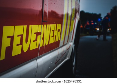 Youth Fire Brigade Exercises At Night In The Rain With Fire Engine. Translation: