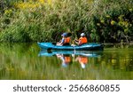 Youth floating in a canoe on the river
