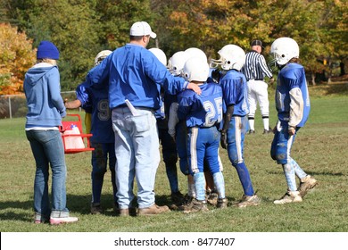 Youth Football Huddle With Coach