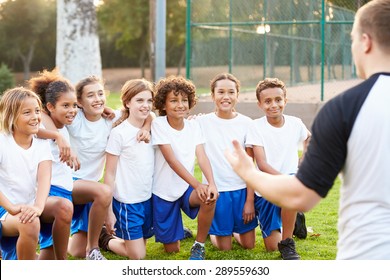 Youth Football Team Training With Coach