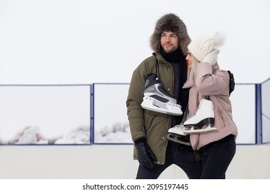 Youth Lifestyle. Young Loving  Caucasian Couple On Skatingrink With Ice Skates Posing Together Embraced Over a Snowy Winter Landscape. Horizontal Composition - Shutterstock ID 2095197445