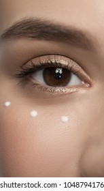 Youth And Skin Care Concept. Close Up Of Young Woman Eye With Drops Of Moisturizer Cream. Selective Focus