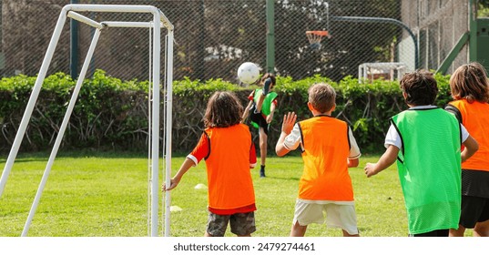 Youth Soccer Match with Colorful Training Bibs - Powered by Shutterstock