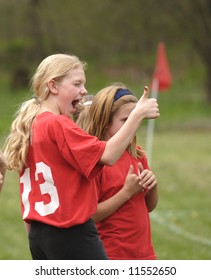 Youth Soccer Player Holding Thumbs Up During Game From Sidelines