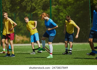 Youth Soccer Training Session. Group of young athletes training outdoors on warm sunny day. Agility and teamwork. Concept of sport, school, childhood, hobby, active lifestyle - Powered by Shutterstock