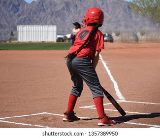 Youth Softball Batter With Long Braid