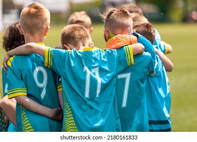 Youth Sports Coach Witch Children On Soccer Field. Kids Huddling Before The Final Tournament Match. Kids Bending Down In Huddle