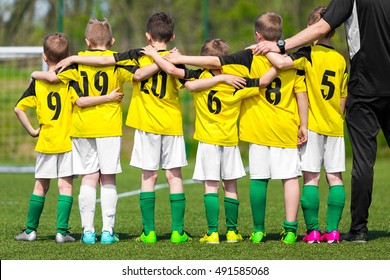 Youth Sports Team. Young Children Players Standing Together With Coach Manager. Youth And Sports; Team Spirit