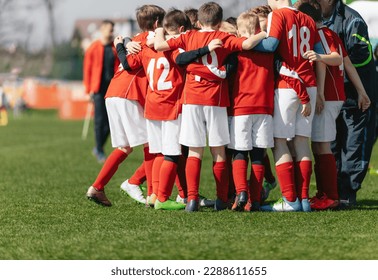 Youth Team Huddle. Sports Players in a Team Meeting With Coach at Soccer Match Half Time Break. Coaching Junior Level European Football Players - Powered by Shutterstock