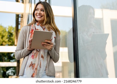 Youth And Technology. Attractive Young Business Woman Using Tablet Computer Outdoors.