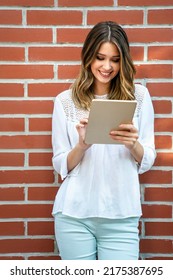 Youth And Technology. Attractive Young Business Woman Using Tablet Computer Outdoors.