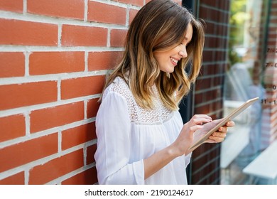 Youth And Technology. Attractive Young Business Woman Using Tablet Computer Outdoors.