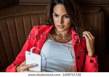 Youth and technology. Young beautiful long hair woman taking selfie by smartphone while sitting at cafe.