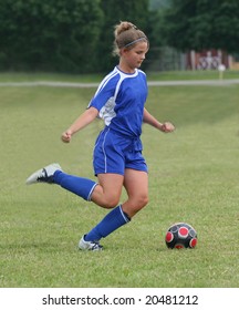 Youth Teen Soccer Player Kicking Ball