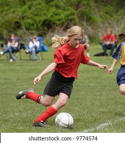 Youth Teen Soccer Player Kicking Ball On Field During Game 3