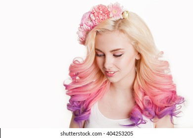 Youth women and colored hair smiling  Flowers in her hair  Studio  isolated  white background  Concept spring  summer  look down