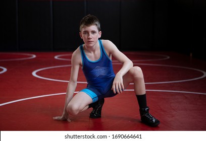 Youth Wrestler On A Red Wrestling Mat