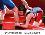 Youth wrestler taking a low single shot on his opponent