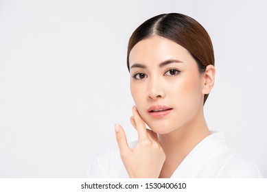 Youthful Radiant Pretty Asian Woman With Hand Touching Face On White Background For Beauty And Skin Care Concepts