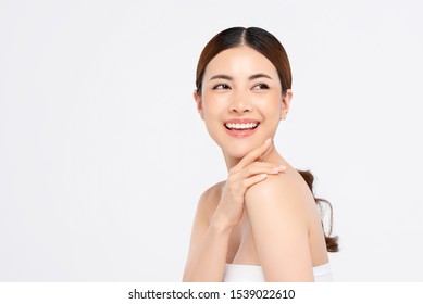 Youthful Smiling Asian Woman With Hand Touching Face Isolated On White Background For Beauty And Skin Care Concepts