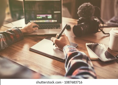 Youtuber editing video on laptop for up to worldwide through an online freelance work. - Shutterstock ID 1087683716