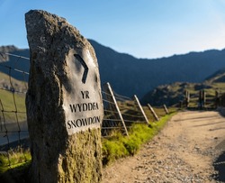 Yr Wyddfa Snowdon Sign Along The Pyg Track Path Ascending The Mountain In Snowdonia (Eryri) National Park Wales (Cymru) Near Sunset