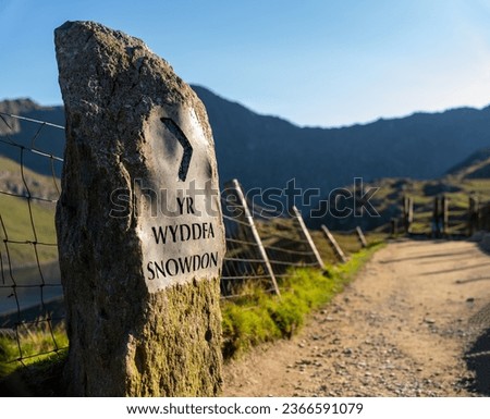 Yr Wyddfa Snowdon Sign along the Pyg Track Path ascending the mountain in Snowdonia (Eryri) National Park Wales (Cymru) near Sunset