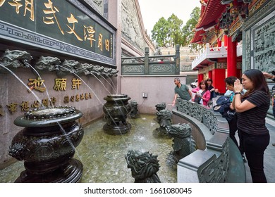 YUCHI/TAIWAN - November 26, 2019: People Praying And Wishing At Wenwu Temple Wish Fountain