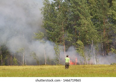 Yuganskiy Nature Reserve, Surgut District, Russia - July 20, 2013 - Firefighter Approaching Wildfire In Siberia