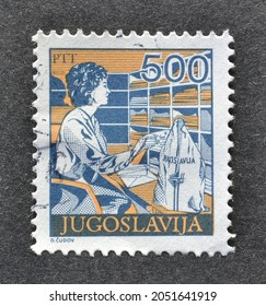 Yugoslavia - Circa 1990 : Cancelled Postage Stamp Printed By Yugoslavia, That Shows Postal Worker Sorting Mail Circa 1990.