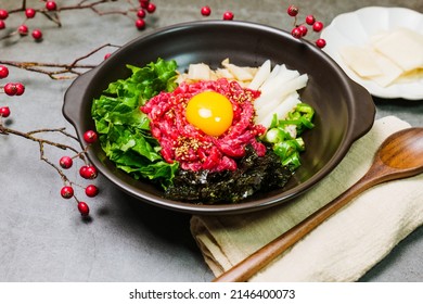 Yukhoebibimbap, Korean style Beef Tartare Bibimbap : This is a bowl of rice topped with seasonal namul (seasoned vegetables) and fresh yukhoe (chopped raw beef) and served with seasoning.